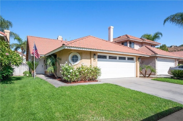 mediterranean / spanish-style house featuring a garage and a front yard