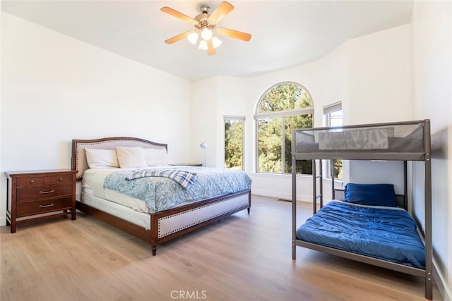 bedroom with ceiling fan and light hardwood / wood-style floors