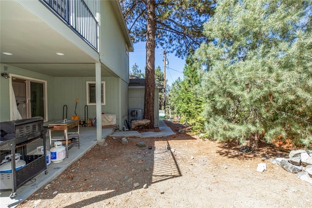 view of yard with a balcony and a patio area