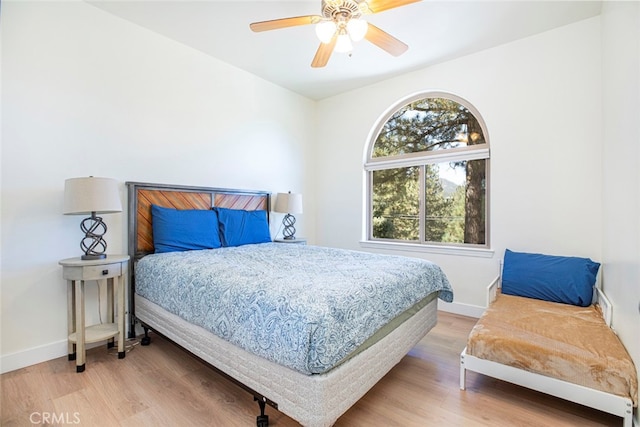 bedroom with ceiling fan and hardwood / wood-style floors