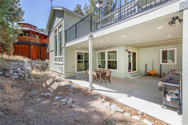 back of house with a balcony and a patio area