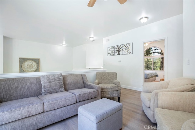 living room featuring ceiling fan and hardwood / wood-style floors