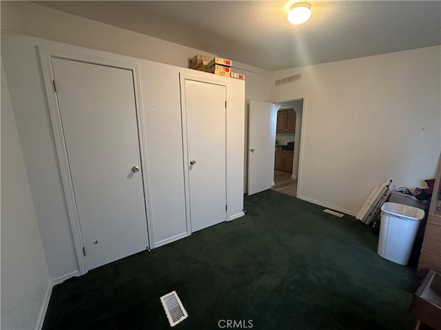 unfurnished bedroom featuring dark colored carpet