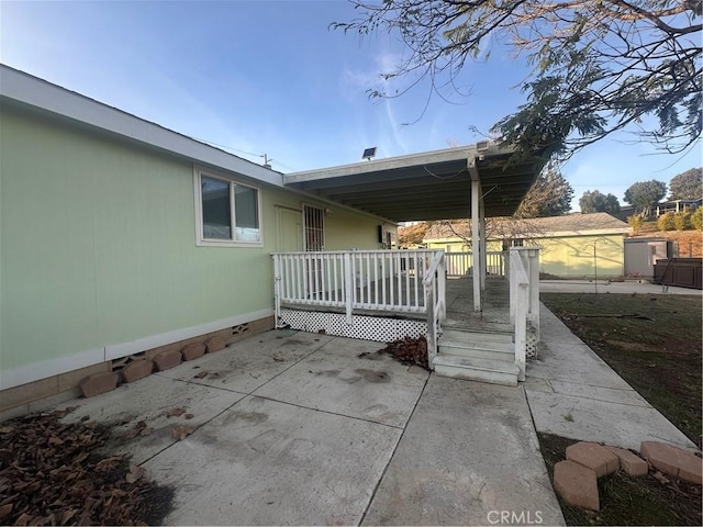 exterior space with a patio area and a deck