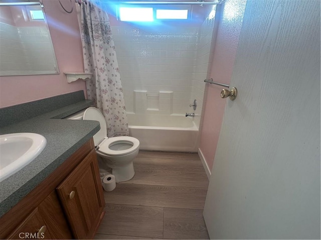 bathroom with toilet, shower / bathtub combination with curtain, wood finished floors, and vanity