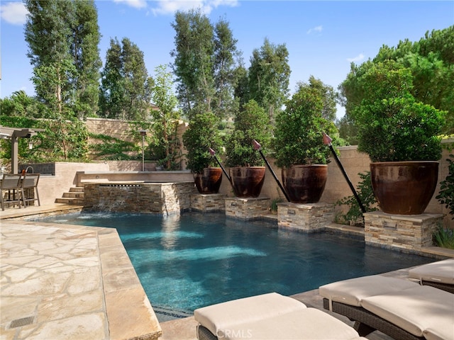 view of swimming pool with pool water feature, a patio area, and a jacuzzi