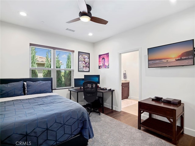 bedroom with ceiling fan, hardwood / wood-style flooring, and ensuite bathroom