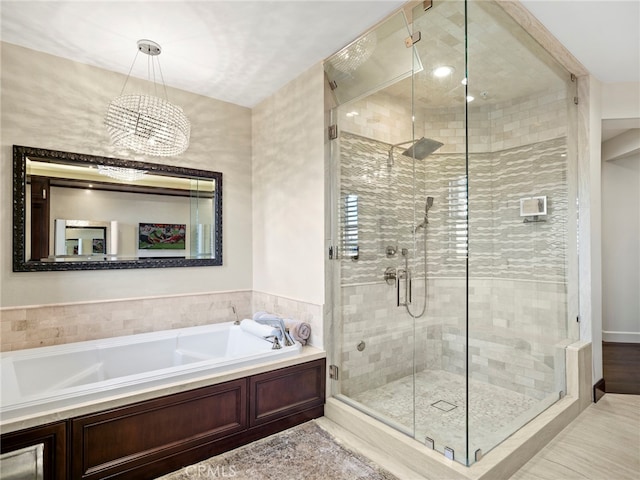 bathroom with a notable chandelier and plus walk in shower