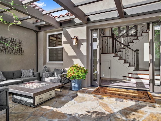 view of patio featuring a pergola and an outdoor living space with a fire pit