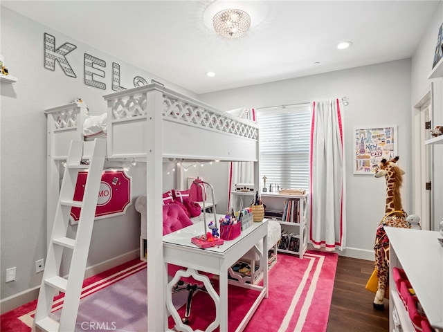 bedroom featuring an inviting chandelier and dark hardwood / wood-style floors