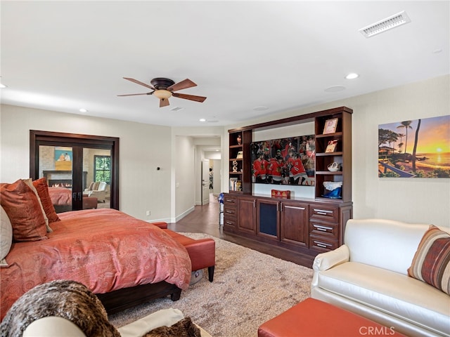 bedroom with hardwood / wood-style floors and ceiling fan