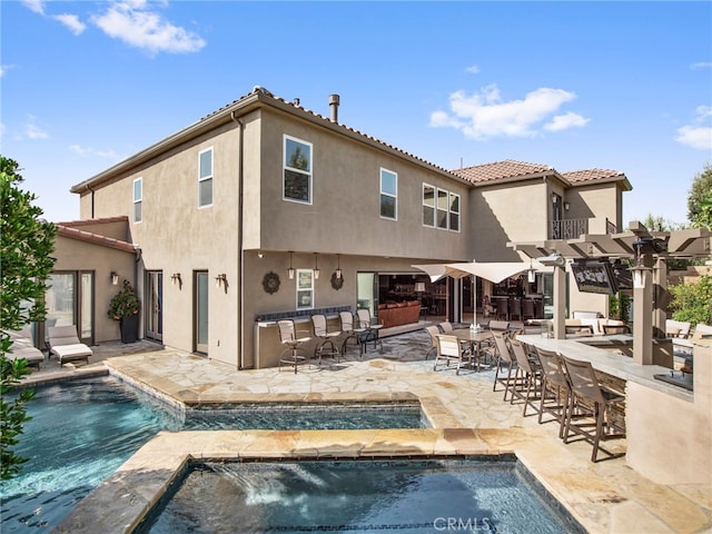 back of house featuring a patio and pool water feature