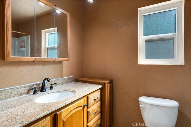 bathroom featuring vanity and toilet