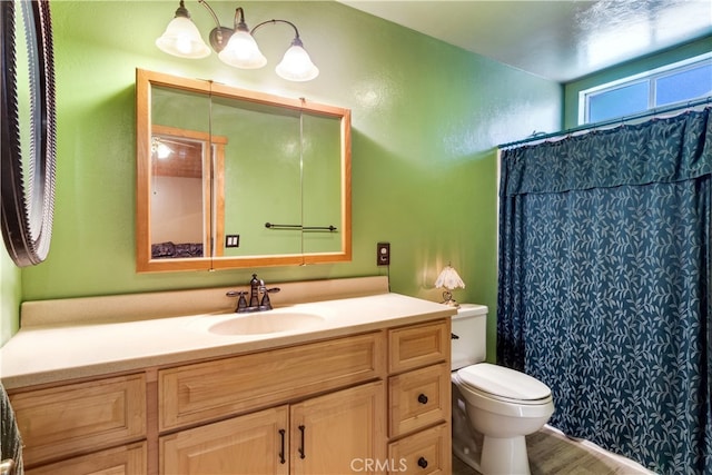 bathroom featuring vanity, hardwood / wood-style floors, toilet, and a shower with shower curtain