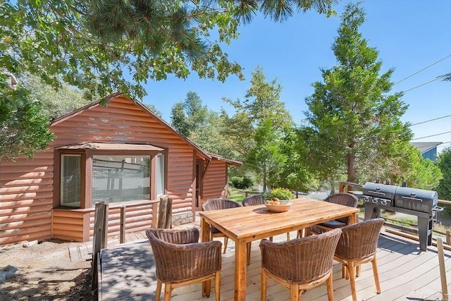 wooden terrace featuring a grill