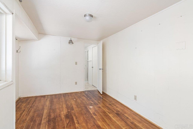 unfurnished room featuring dark hardwood / wood-style flooring