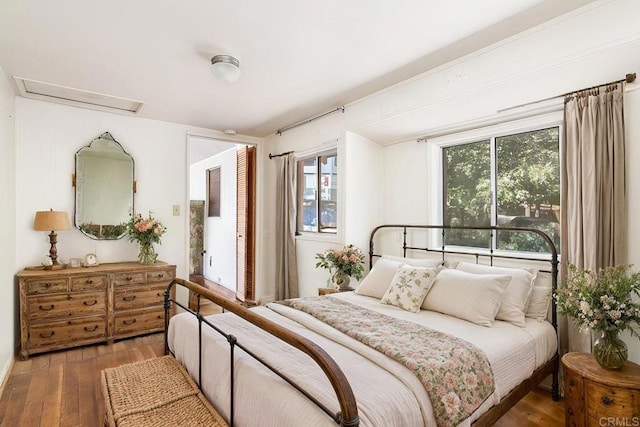 bedroom with dark hardwood / wood-style floors