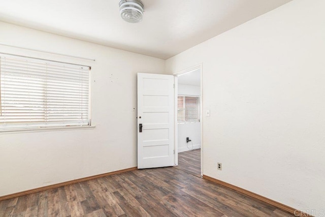 unfurnished room featuring dark hardwood / wood-style floors