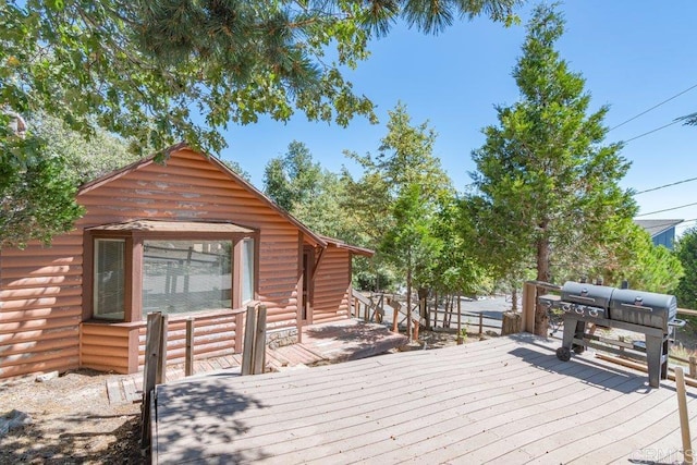 wooden terrace featuring area for grilling