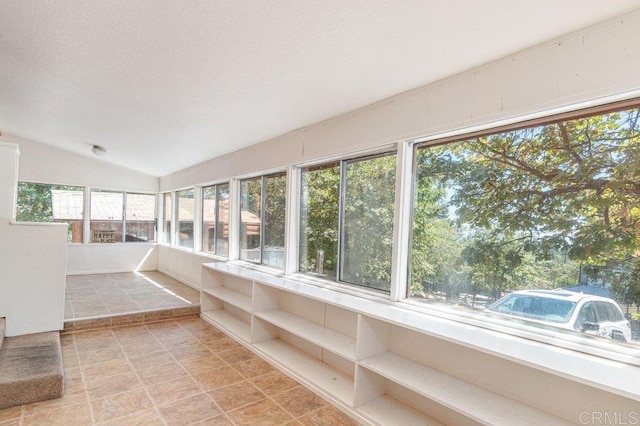 unfurnished sunroom with vaulted ceiling