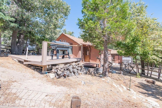 rear view of property featuring a wooden deck