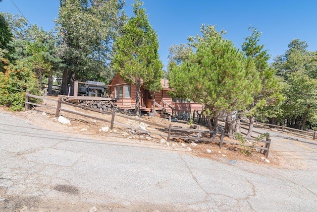 log-style house with a wooden deck