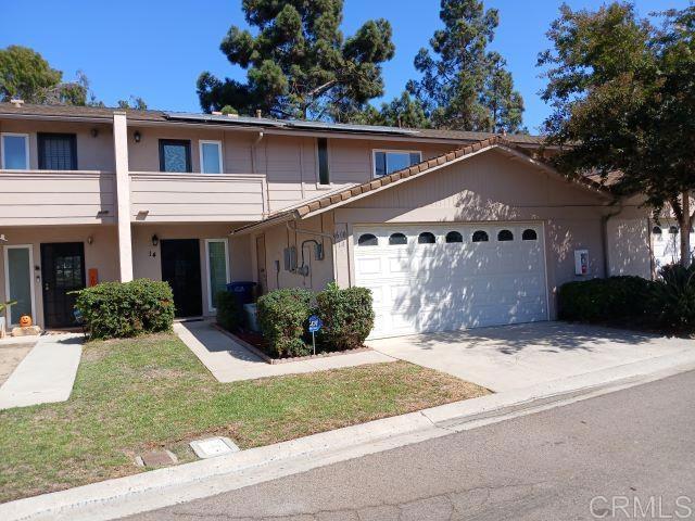 view of property with a front yard and a garage