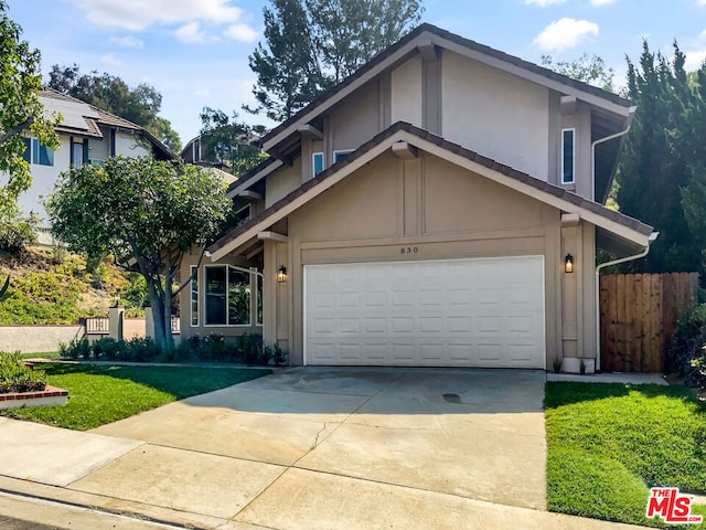 view of front of property featuring a front lawn and a garage