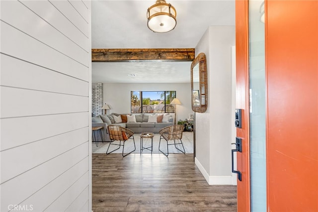 foyer with dark wood-type flooring and beam ceiling