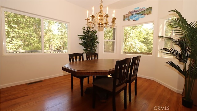 dining area with a chandelier and hardwood / wood-style floors