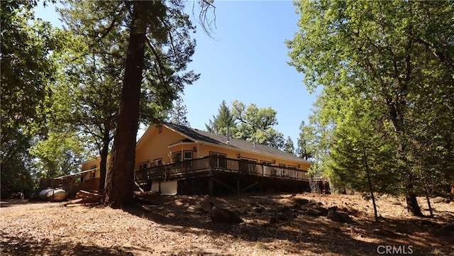 back of house featuring a wooden deck