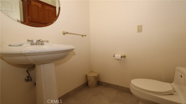 bathroom with tile patterned flooring and toilet