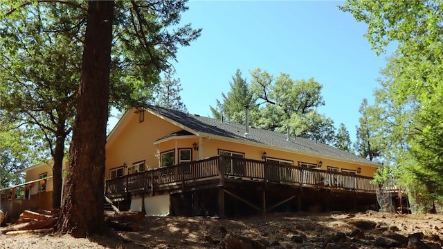 back of property with a wooden deck