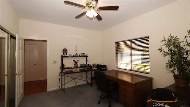 office with dark carpet and ceiling fan