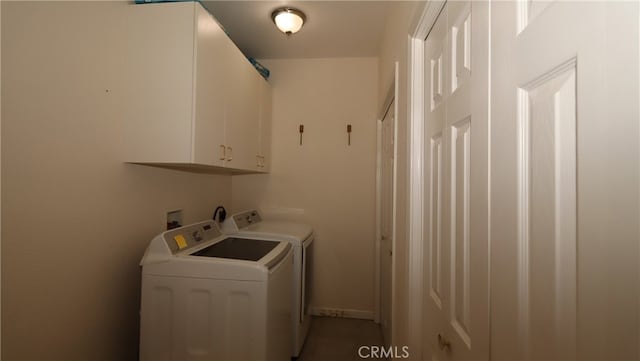 laundry area with cabinets and washer and clothes dryer