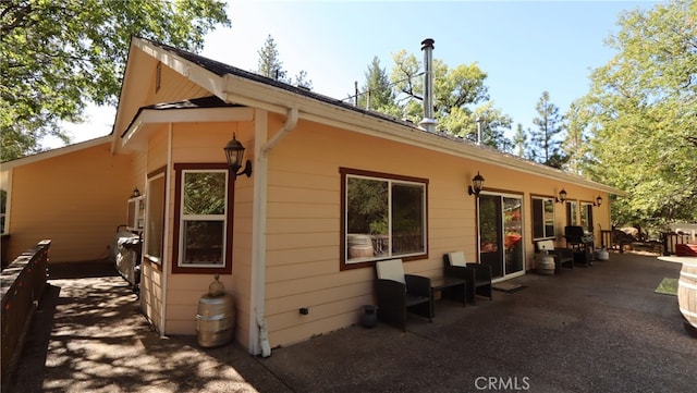 view of side of home featuring a patio area