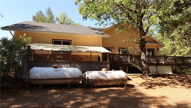 back of property featuring a wooden deck