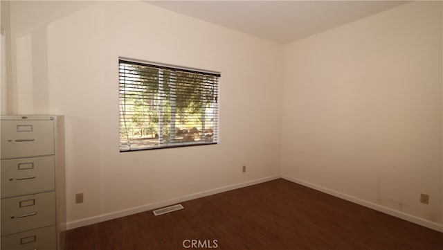 spare room featuring dark hardwood / wood-style flooring