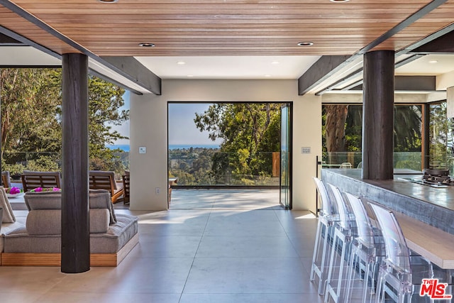 entryway with a wealth of natural light and wooden ceiling