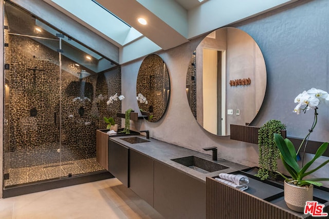 bathroom featuring vanity, lofted ceiling with skylight, and a shower with door