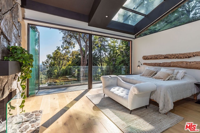 bedroom featuring light hardwood / wood-style flooring and lofted ceiling