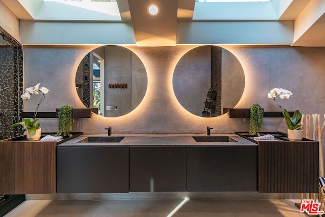 bathroom with a skylight and sink