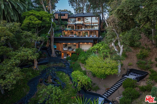 rear view of property with a balcony