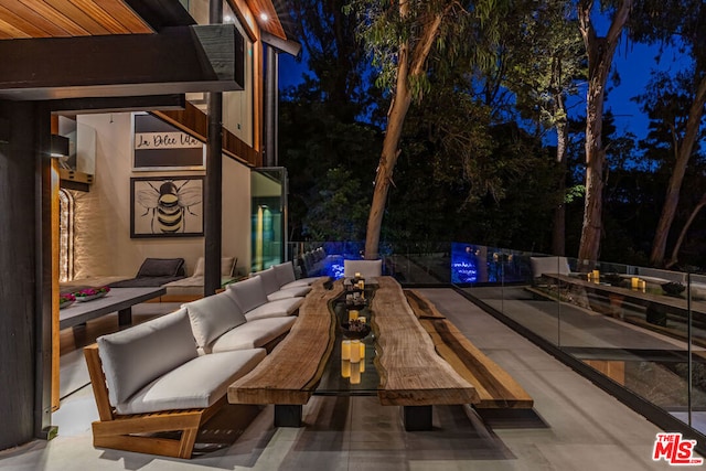 patio at twilight featuring an outdoor hangout area