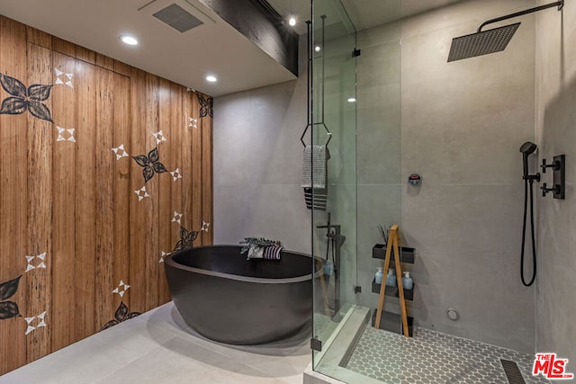 bathroom featuring tile patterned flooring and shower with separate bathtub