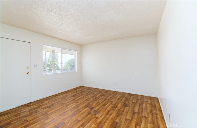 interior space featuring a textured ceiling and hardwood / wood-style floors