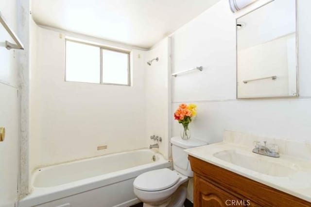 full bathroom featuring washtub / shower combination, vanity, and toilet