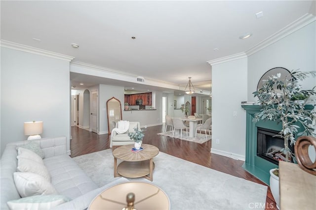 living room with dark hardwood / wood-style flooring and ornamental molding