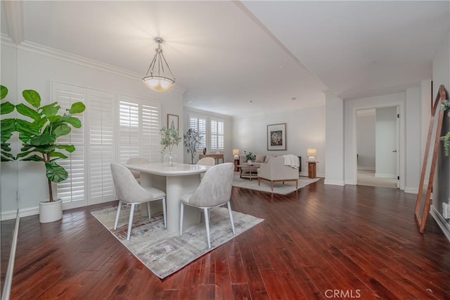 dining room with dark wood-type flooring and ornamental molding