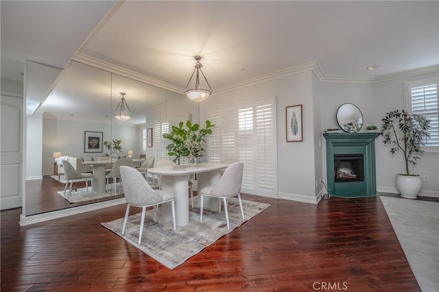 dining space with dark hardwood / wood-style flooring and ornamental molding